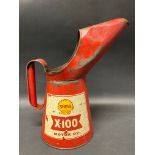 A Shell X-100 Motor Oil quart measure.