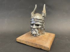 A Rover car mascot in the form of a Viking head, display base mounted.