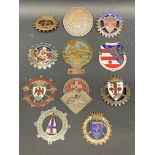 A tray of Swiss and Italian car badges including one signed Huguemin.