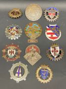 A tray of Swiss and Italian car badges including one signed Huguemin.