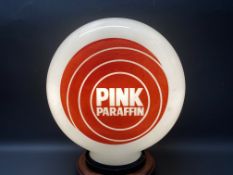 A Pink Paraffin glass petrol pump globe, chip to neck under rubber ring.