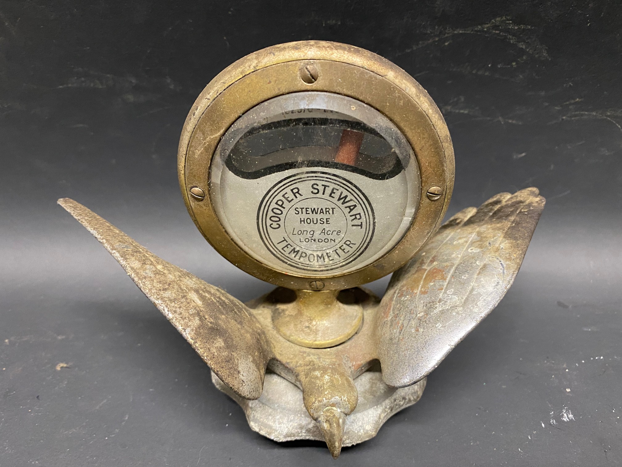 A Cooper Stewart tempometer mounted on a radiator cap with wings.