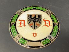 A German circular enamel car badge bearing three dates between 1899-1948, stamped to verso, 4"