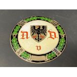 A German circular enamel car badge bearing three dates between 1899-1948, stamped to verso, 4"