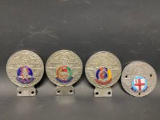 Four St. Christopher car badges, each with a regimental enamel disc including Royal Tank Regiment