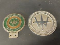A Westinghouse Motor Club car badge and one other.