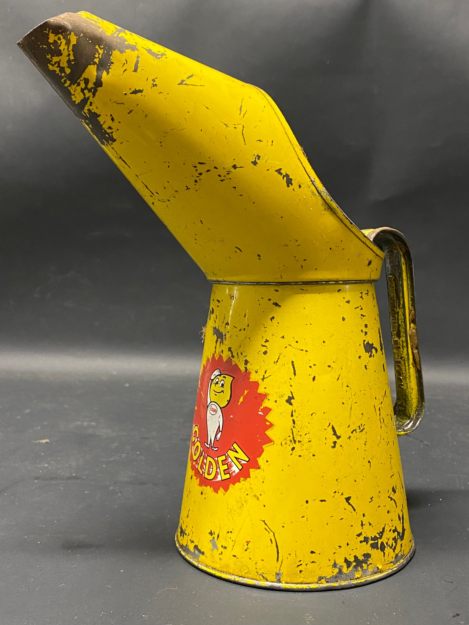 An Esso Golden quart oil measure.