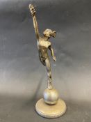 An accessory car mascot in the form of Mercury standing on one leg, radiator cap mounted.