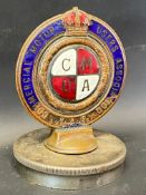 A Commercial Motor Users Association enamel car badge, mounted on a radiator cap, no. 13040.