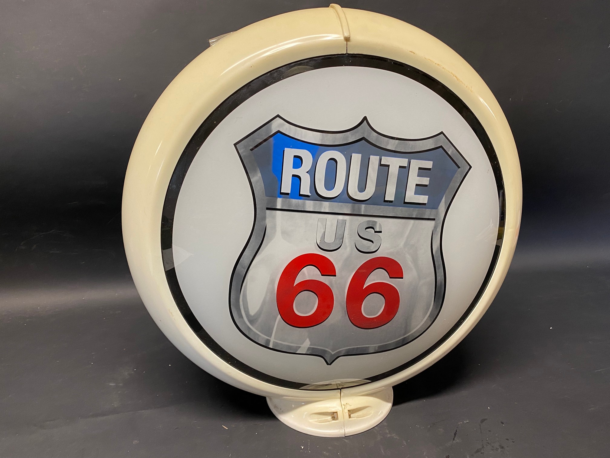 A modern plastic and glass petrol pump globe bearing the words Route 66.