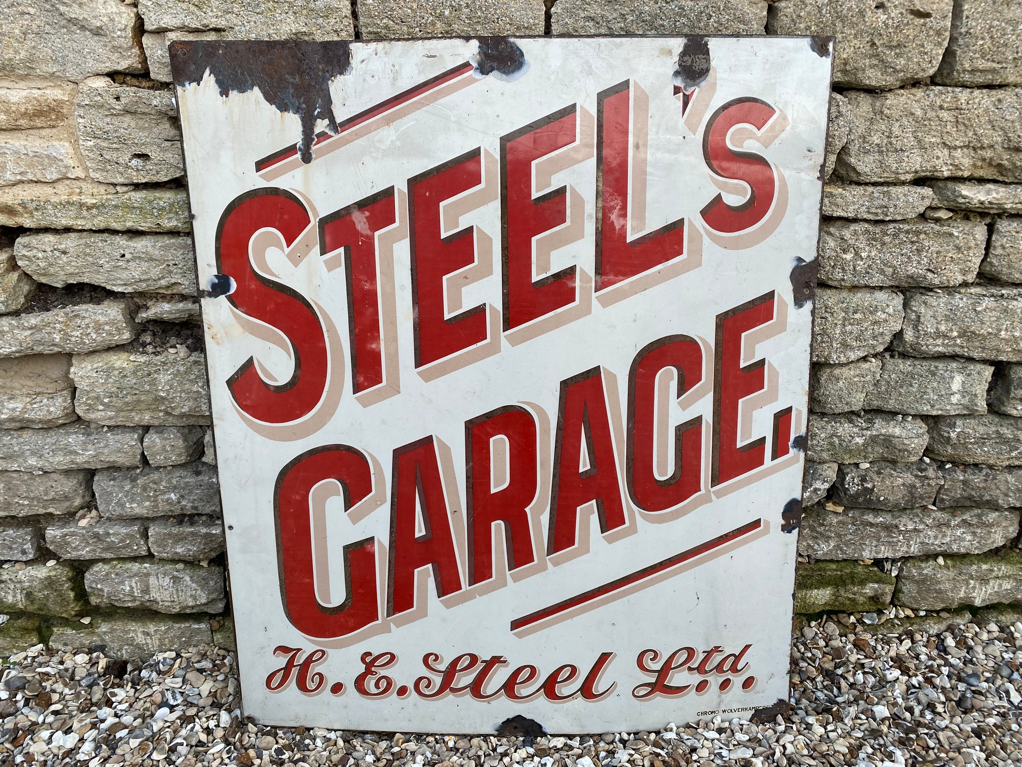 A rectangular enamel sign for Steel's Garage of Cheltenham (H.E. Steel Ltd.), made by Chromo, 36 x