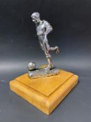 A Desmo accessory mascot in the form of a footballer, display base mounted.