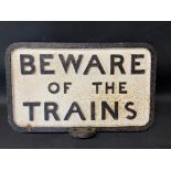 A cast iron 'Beware of the Trains' sign, with unusual mounting point, 20 1/2 x 13 1/2".