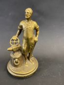 A polished brass blacksmith accessory car mascot.