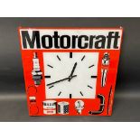 A Motorcraft plastic battery-operated garage wall clock, 15 x 15 3/4".