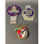 A Royal Order of Moose car badge, a Royal Artillery car badge and one other.