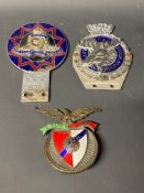A Royal Order of Moose car badge, a Royal Artillery car badge and one other.