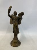 A car accessory mascot in the form of a winged female figure holding a feather aloft.