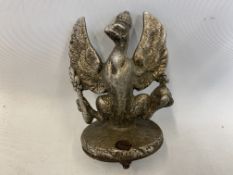 A car accessory mascot in the form of a griffin, unusual form and of light material.