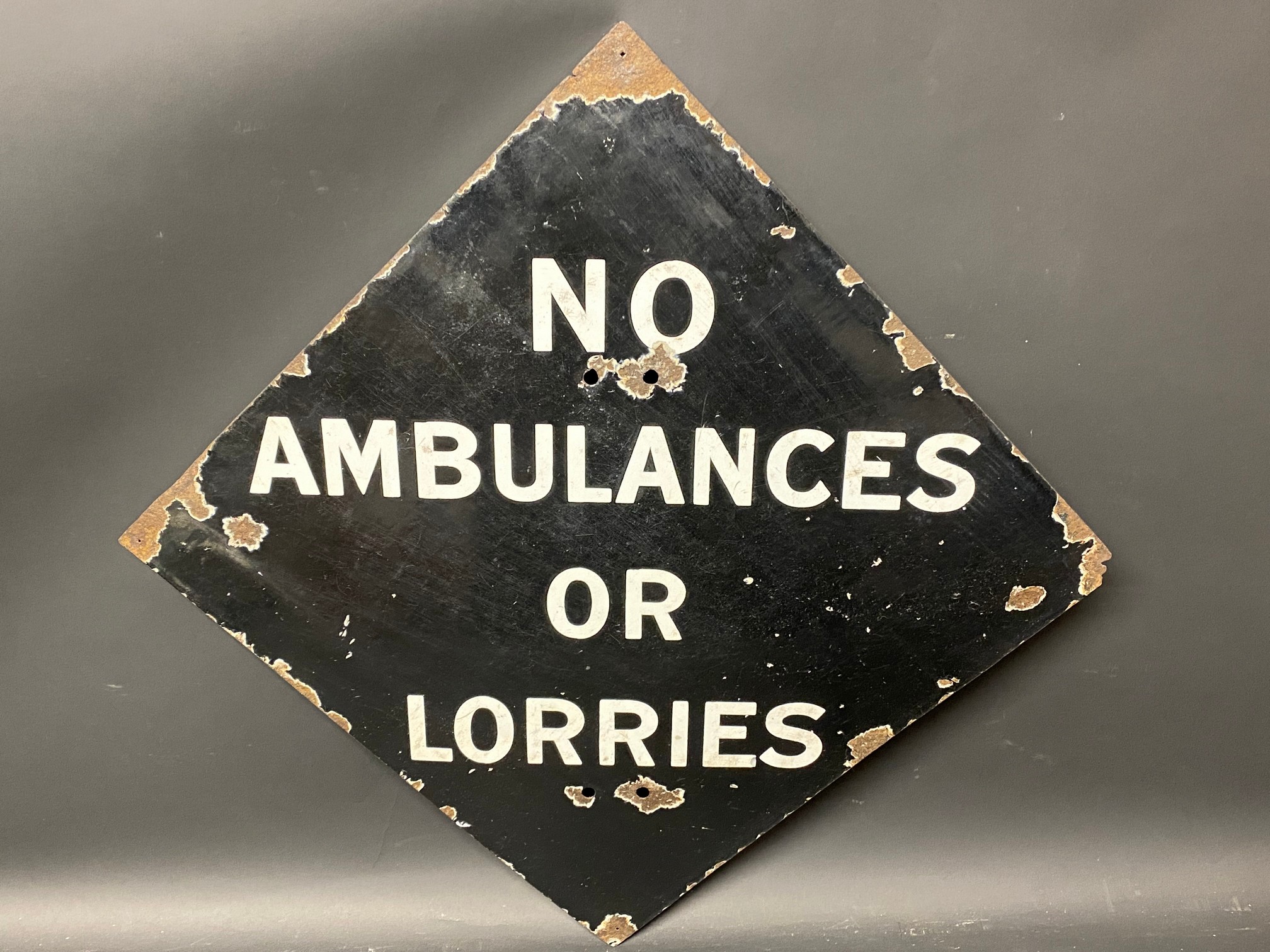 A lozenge shaped enamel sign bearing the words 'No Ambulances or Lorries', probably WWII period,