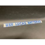A Lucas Batteries shelf strip with raised lettering.