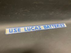 A Lucas Batteries shelf strip with raised lettering.