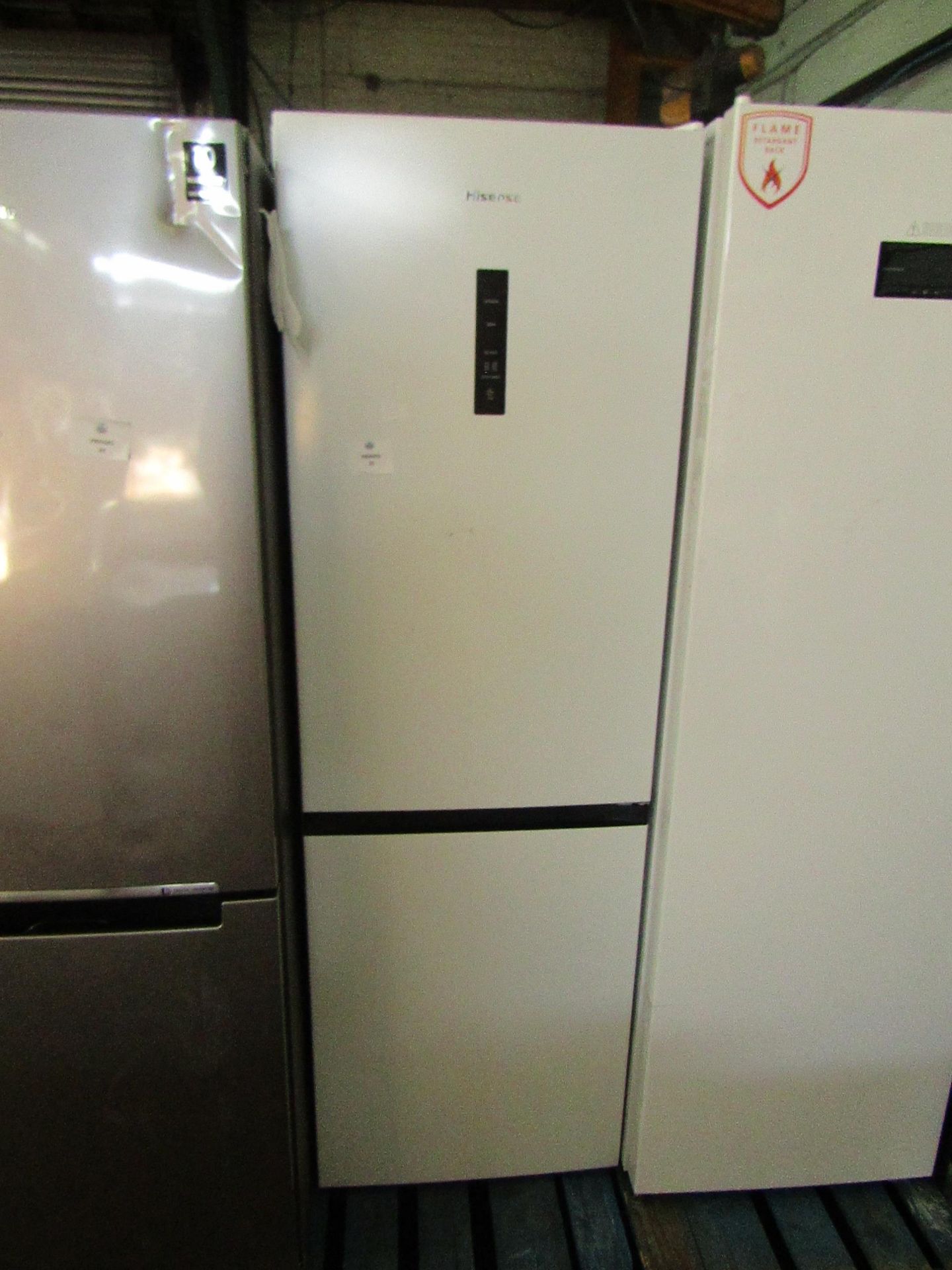 Hisense Fridge freezer, clean insode and one small dent on the freezer door, Tested working for