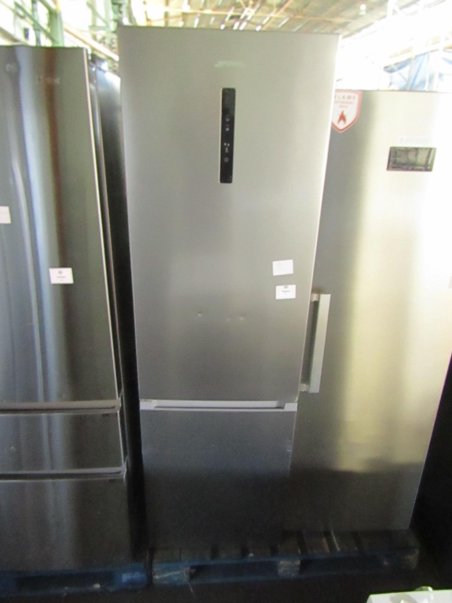 Smeg fridge freezer, clean insode, has a couple of dents nad ,arkls on the front, tested working for
