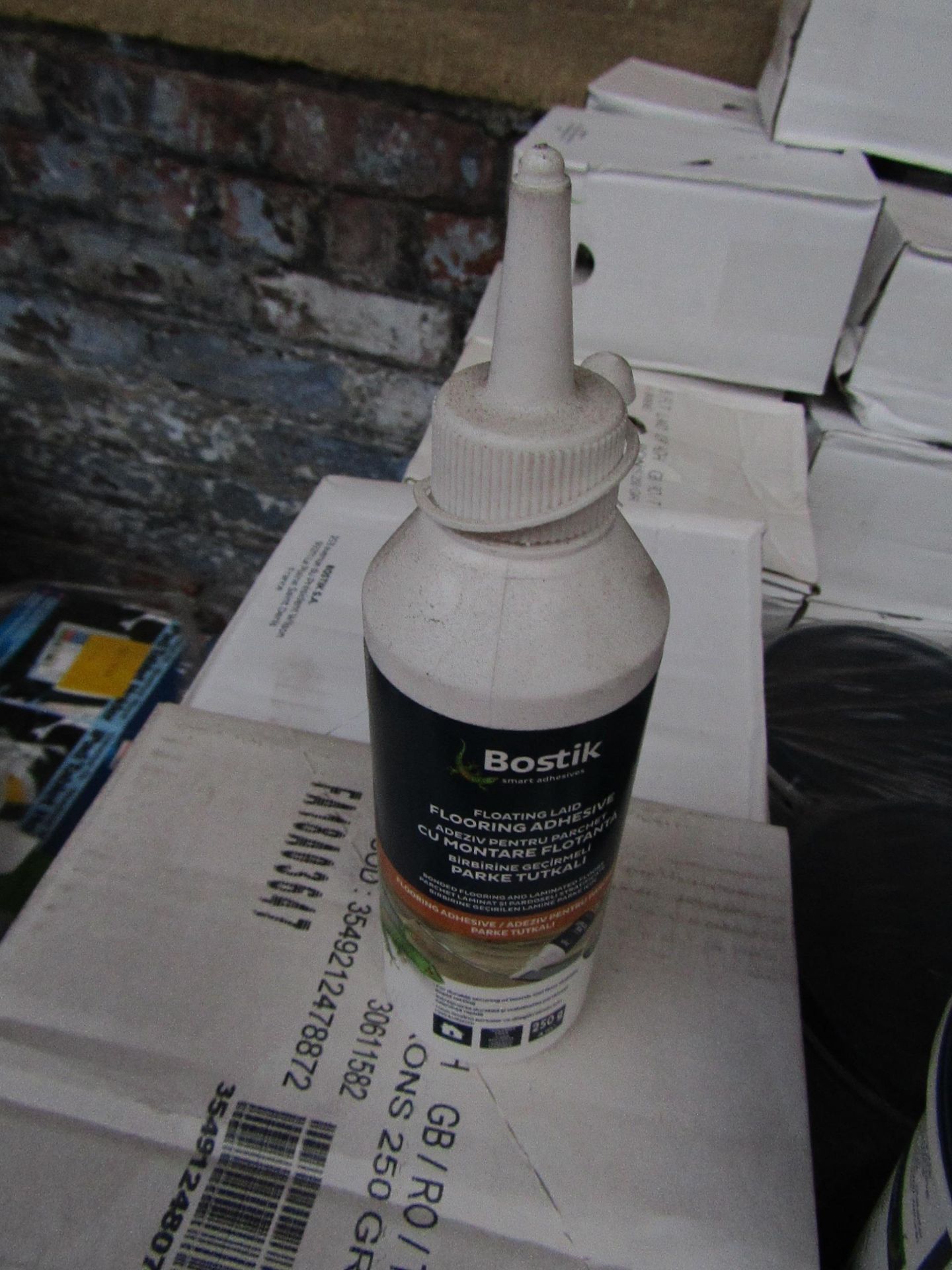 Box of 6x 250g bottles of Bostik Laminate floor adhesive, new and still sealed