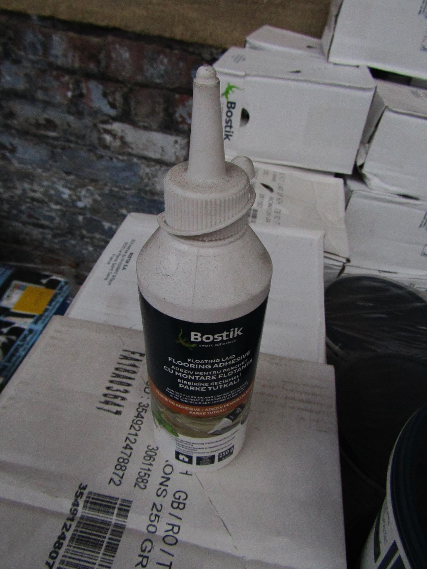 Box of 6x 250g bottles of Bostik Laminate floor adhesive, new and still sealed