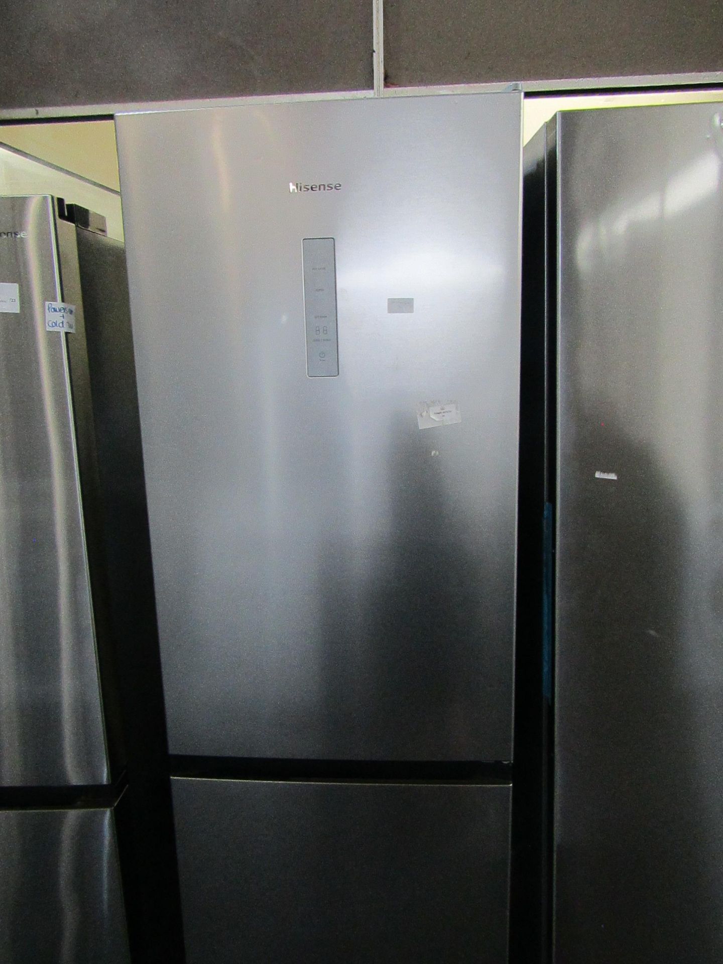 Hisense 60/40 fridge freezer, clean inside and a couple of small dents on the fridge door, tested