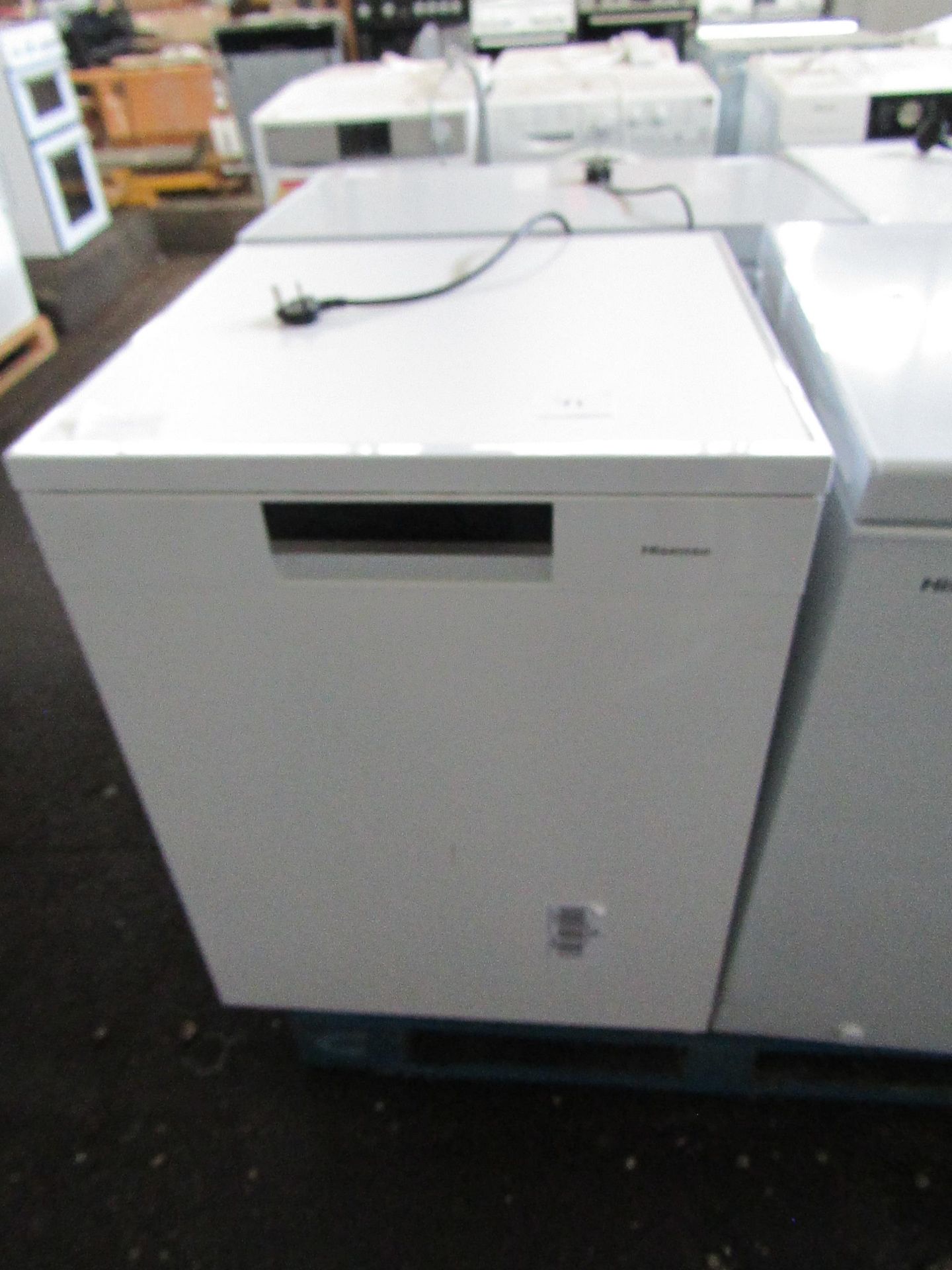 Hisense Dishwasher, Powers on and looks unused , has a scratch on the front nada dent onm the side
