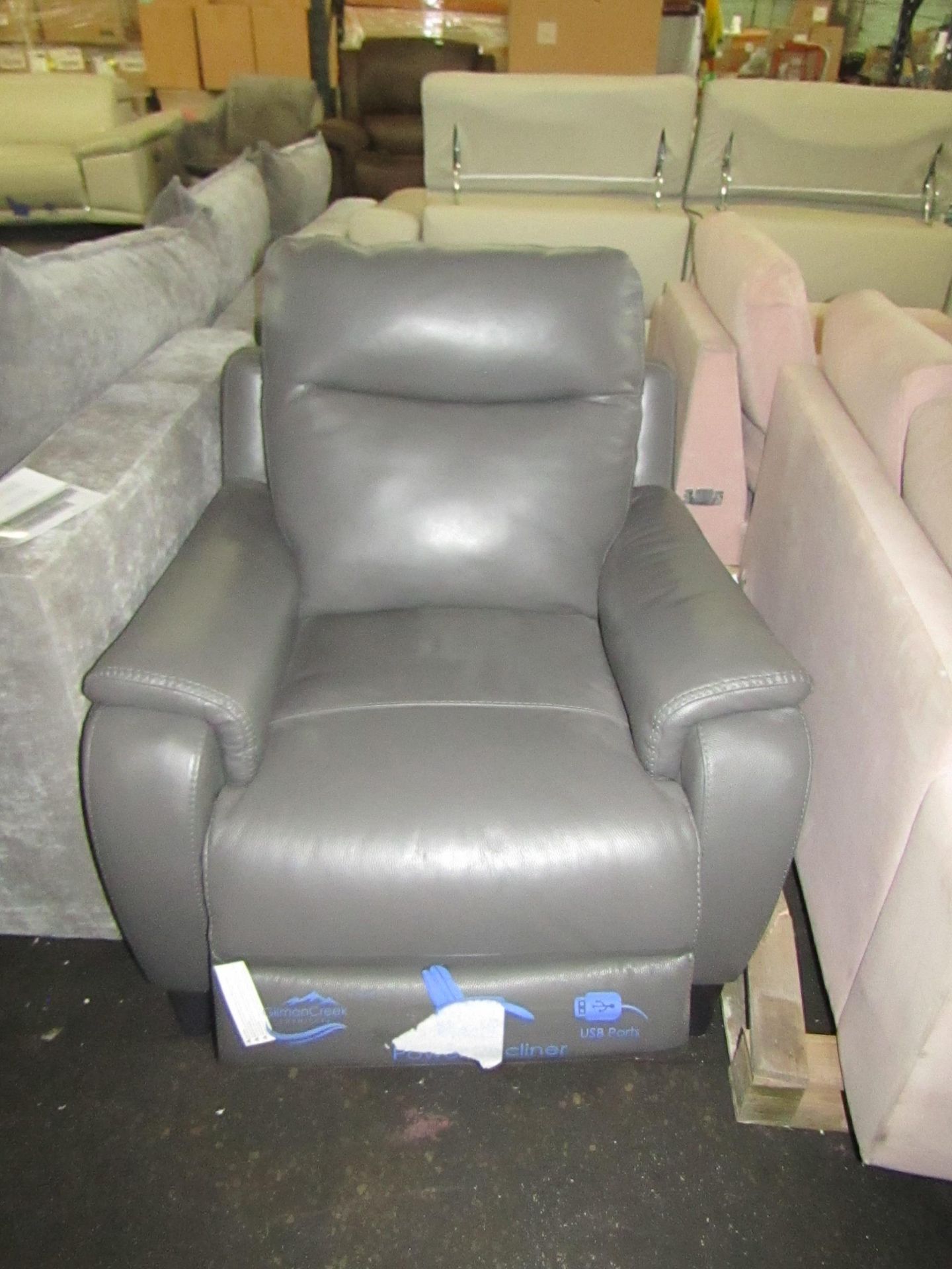 Grey leather Costco reclining arm chair, tested working but the piece of wood on one side that the