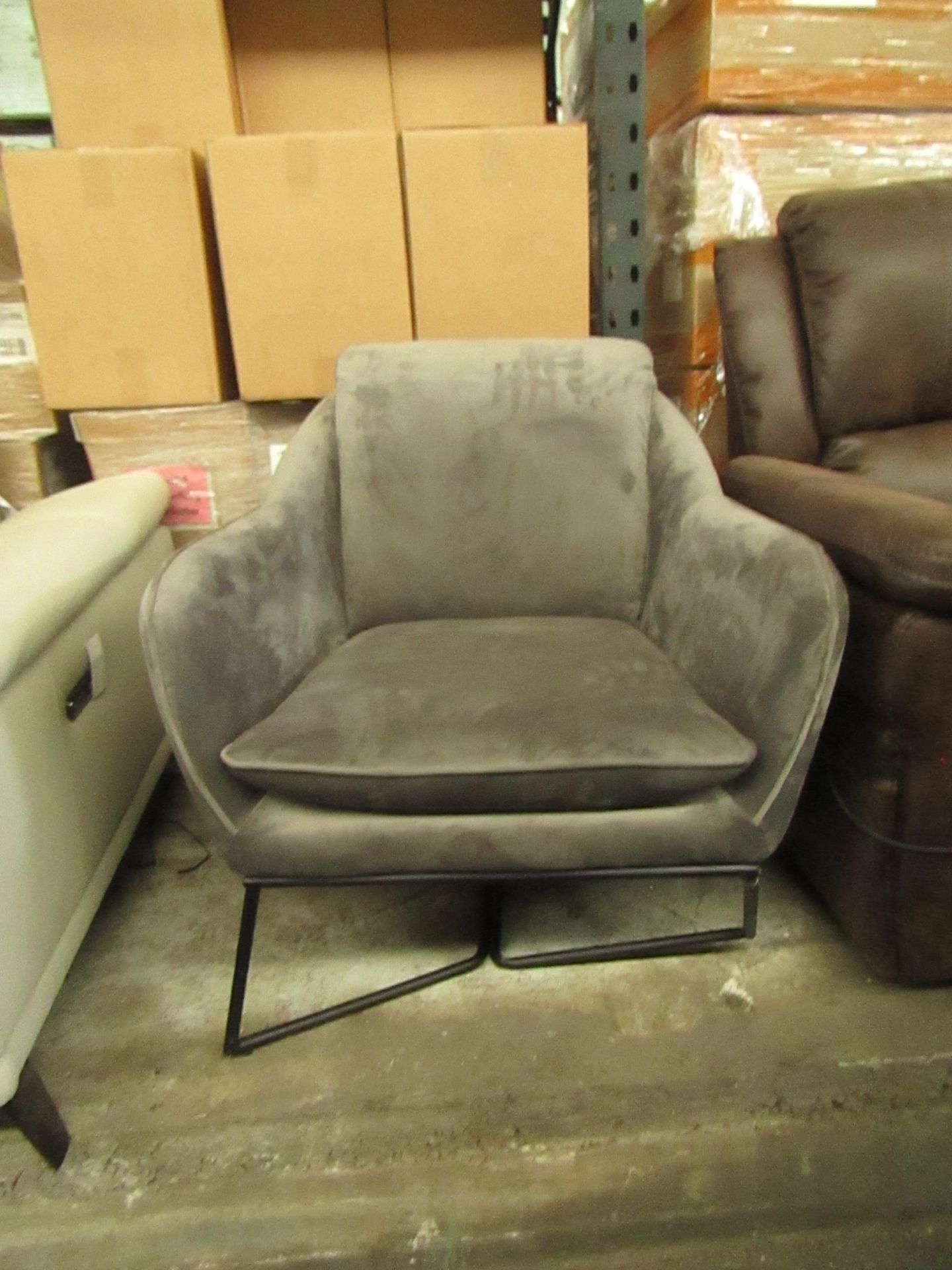 Grey Velour style accent armchair, the leg at he front has been pushed back out of shape