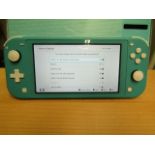 Nintendo Switch Lite hand held games console, powers on and goes to the wifi set up menu, comes with