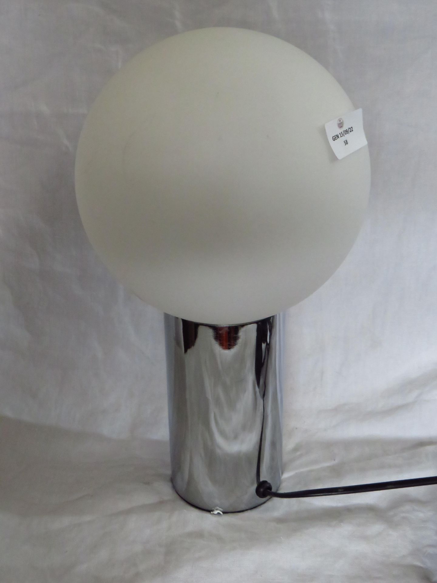 Bedside table lamp with shade.