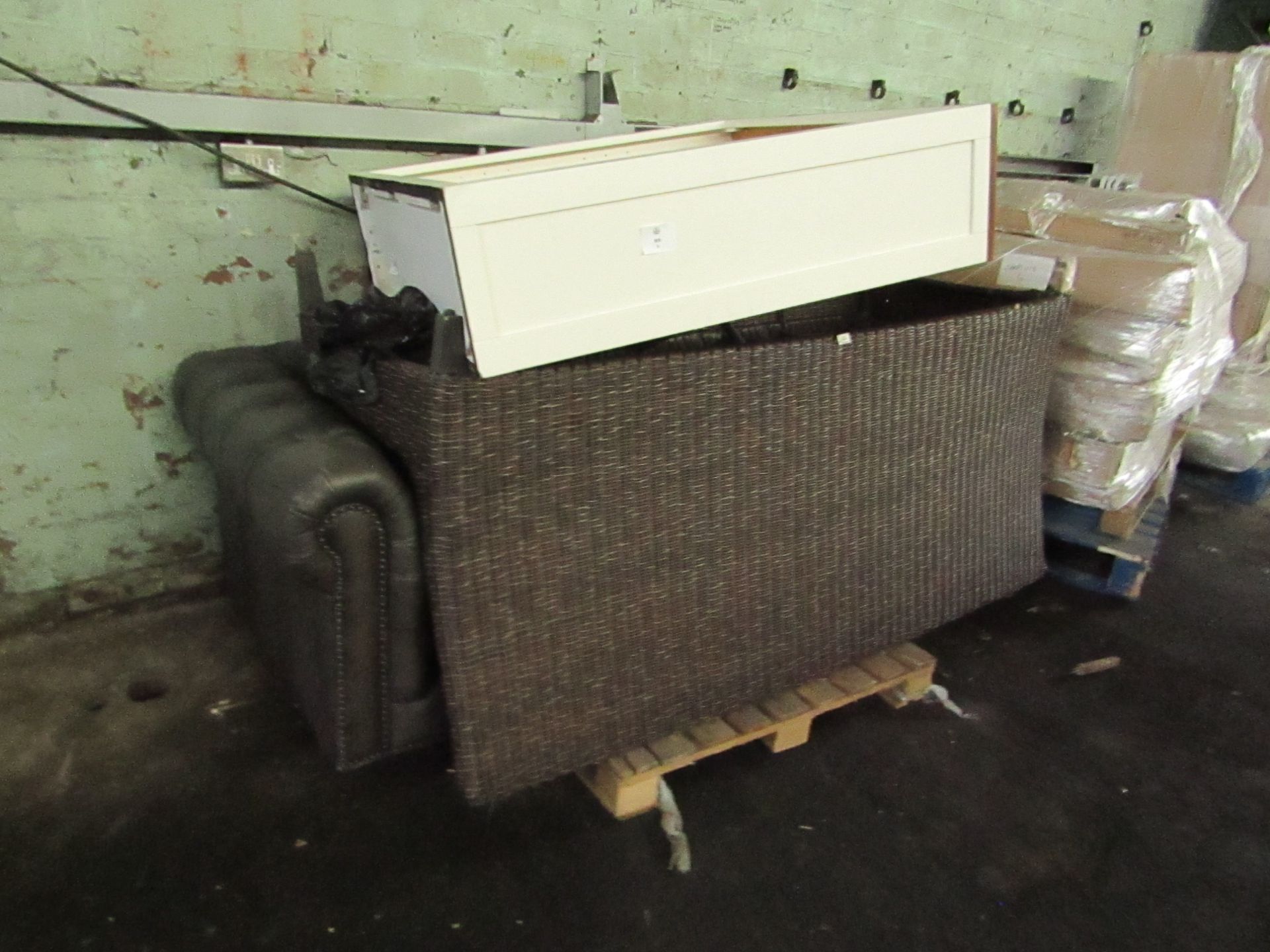 Pallet containing a leather sofa (missing cushions), Ratan sofa and a dresser top.