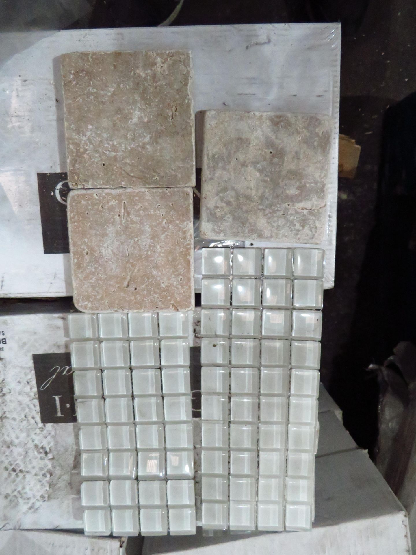 Mixed pallet of tiles that includes 20x packs of 50 travertine rumbled wall tiles and approx 15