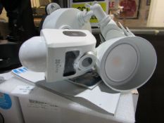 Ezviz Security Light camera, in white, looks unused but the thumb turn connection screw is