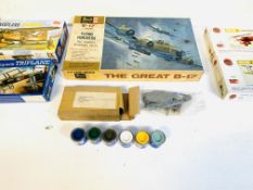 Six assorted plastic model aeroplane kits; together with six paint pots.