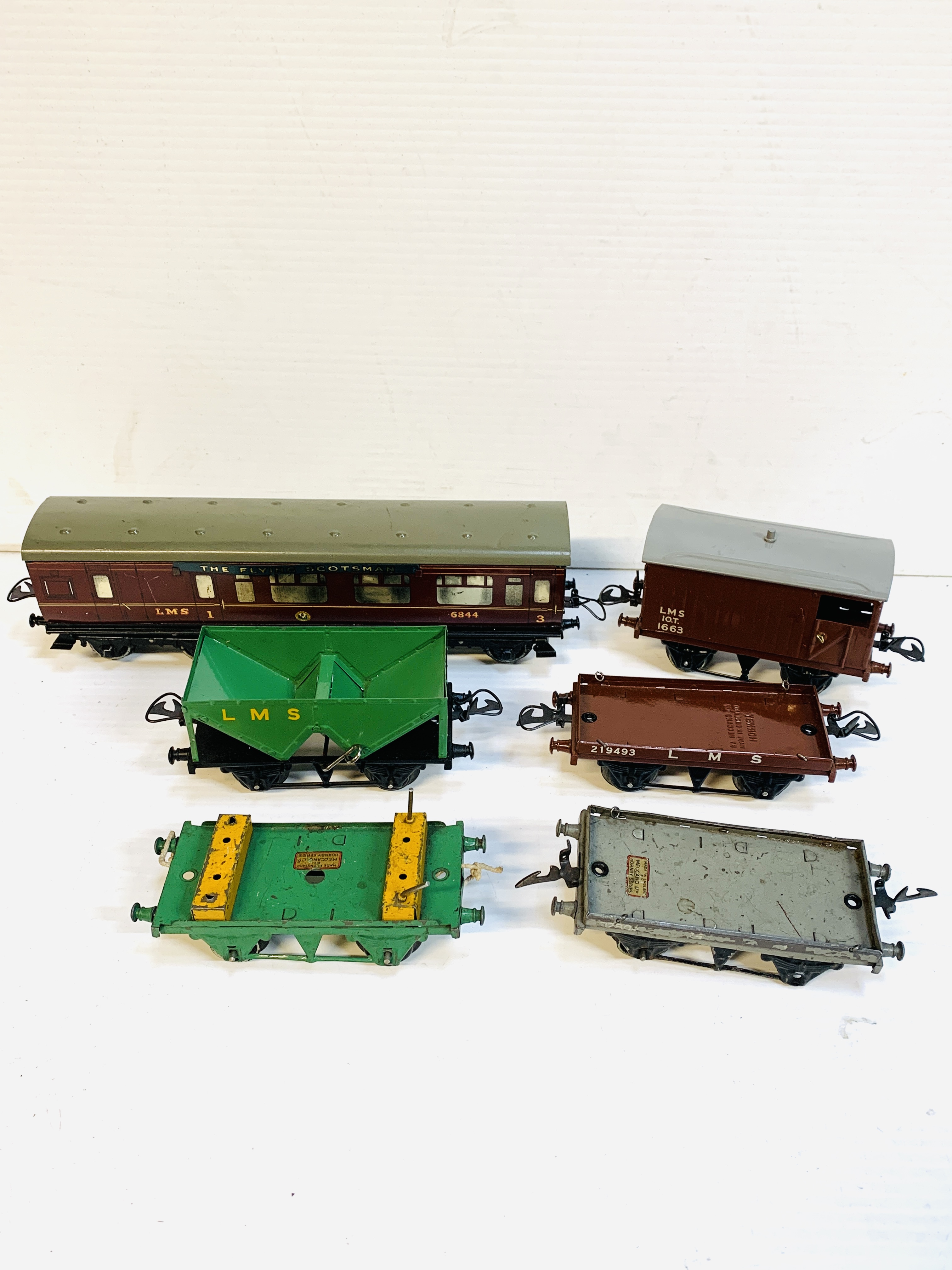 A Hornby 'O' gauge tinplate coach together with five goods wagons