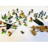 A quantity of plastic soldiers and cowboys, together with a Corgi gun tractor and a field gun.