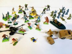 A quantity of plastic soldiers and cowboys, together with a Corgi gun tractor and a field gun.