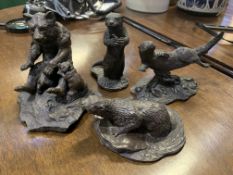 Bronze coloured metal figurine of a bear and three otter figurines