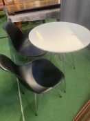 White laminate top table with two black plastic moulded chairs