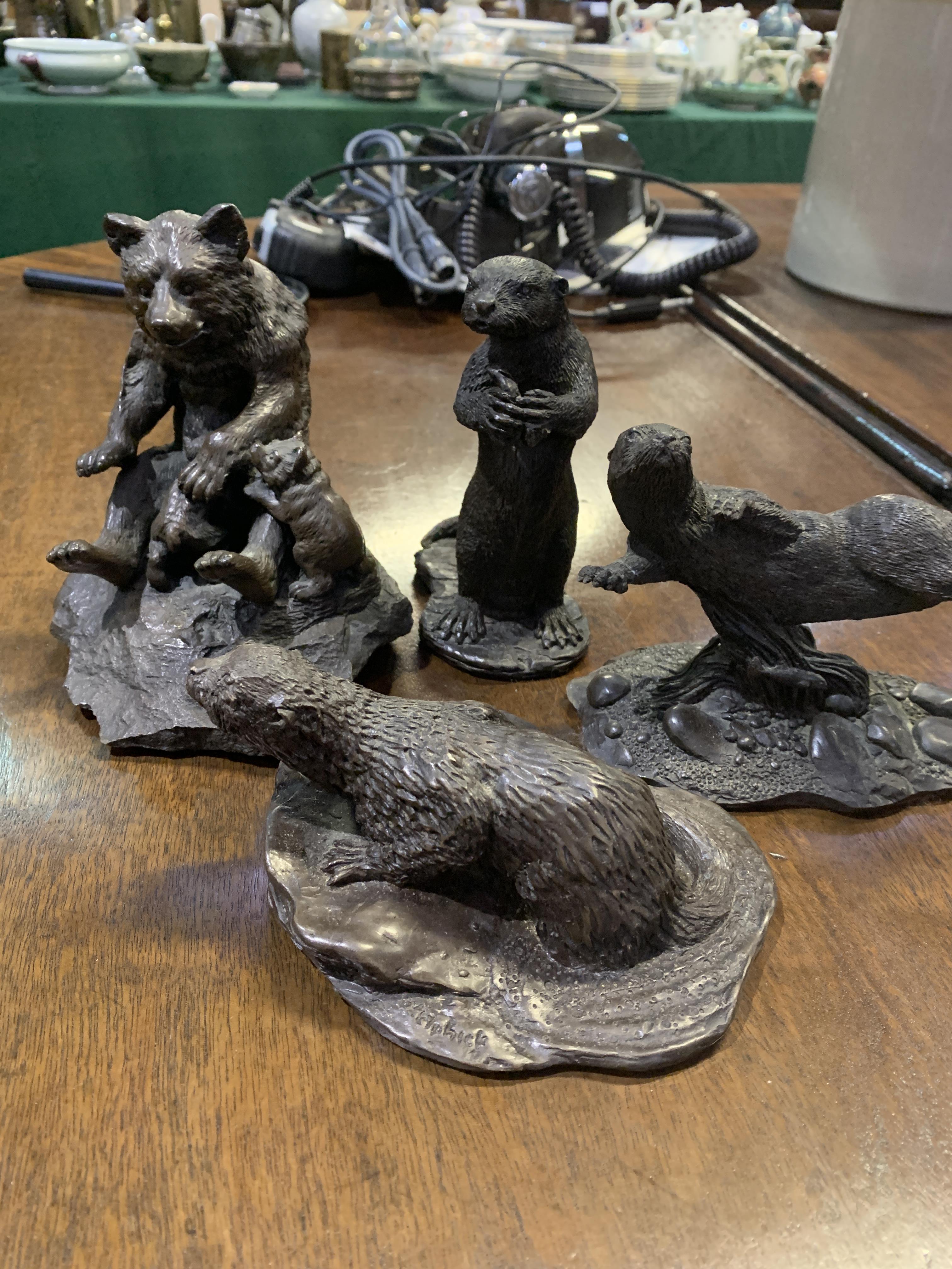 Bronze coloured metal figurine of a bear and three otter figurines - Image 4 of 4