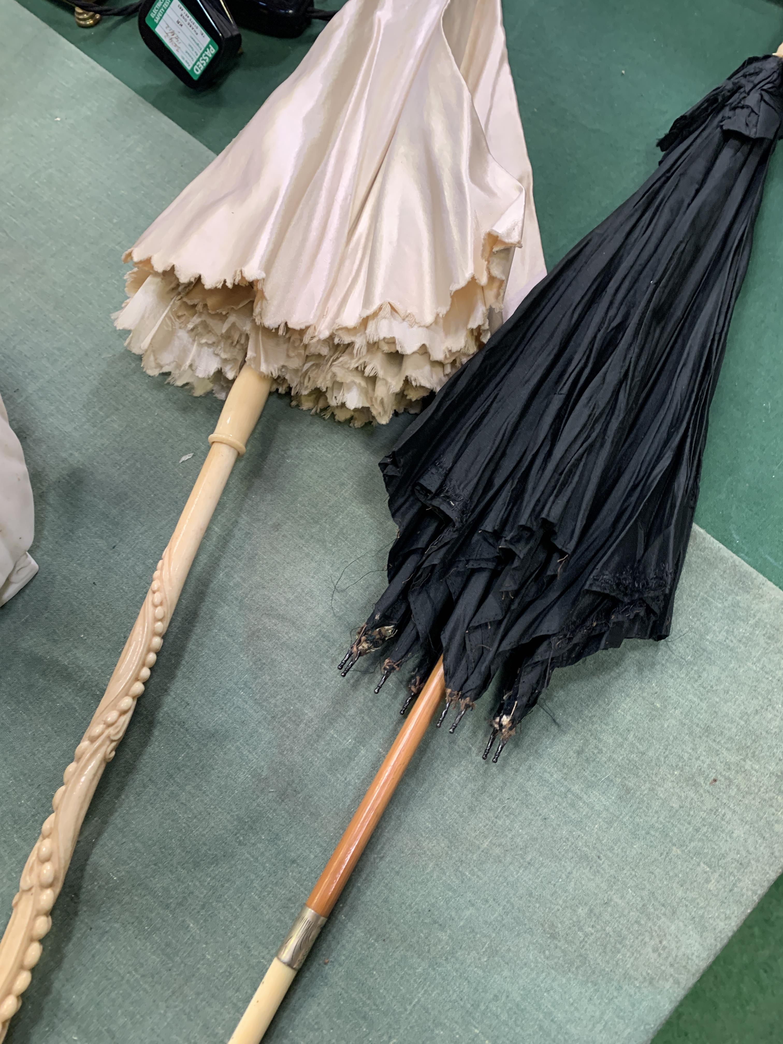 Two ivory handle Victorian parasols. CITIES regulations apply to this lot.