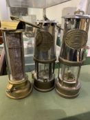 Two brass and chrome safety lamps and a brass heat lamp