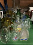 20 assorted branded glass jugs and bottles.