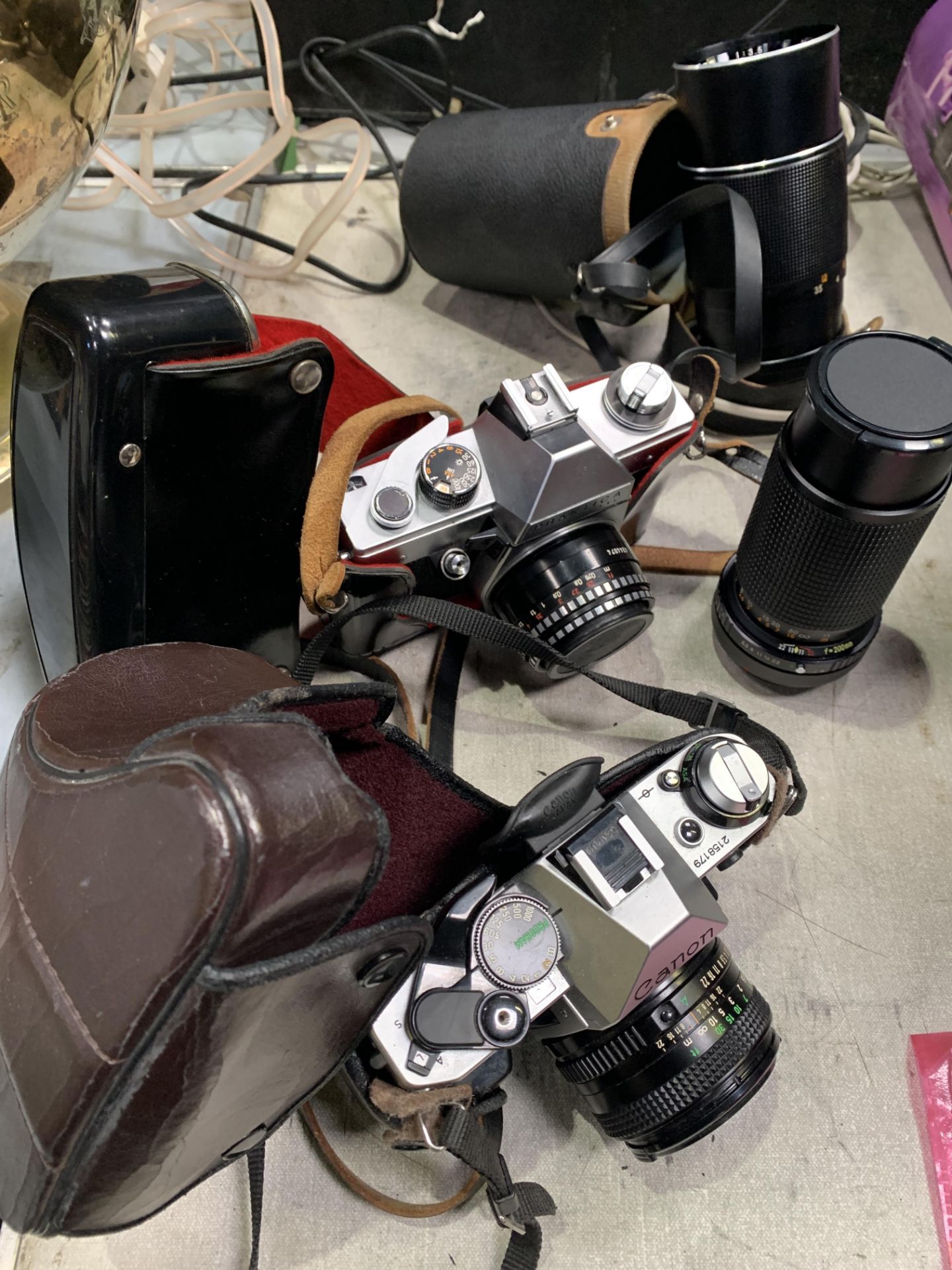 A collection of four cameras and accessories